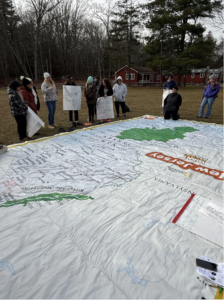 Teachers use a large New Jersey map to examine climate equity patterns and regional climate impacts while developing place-based climate lessons.