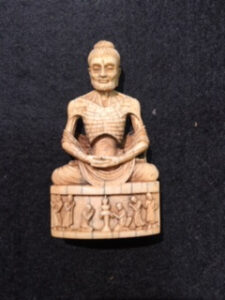 Small ivory carving of Buddha in Lotus position.