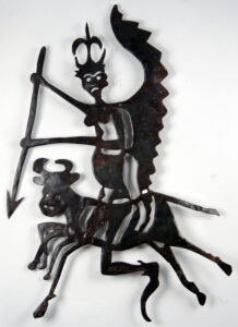 A metal winged demon with a spear riding a cow.
