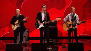 3 of the Box Tops on stage playing guitar