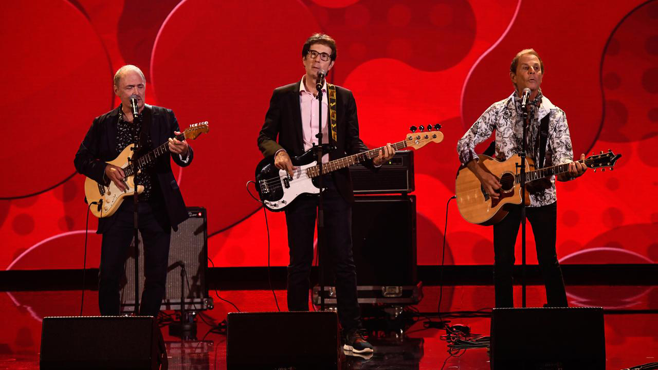 3 of the Box Tops on stage playing guitar