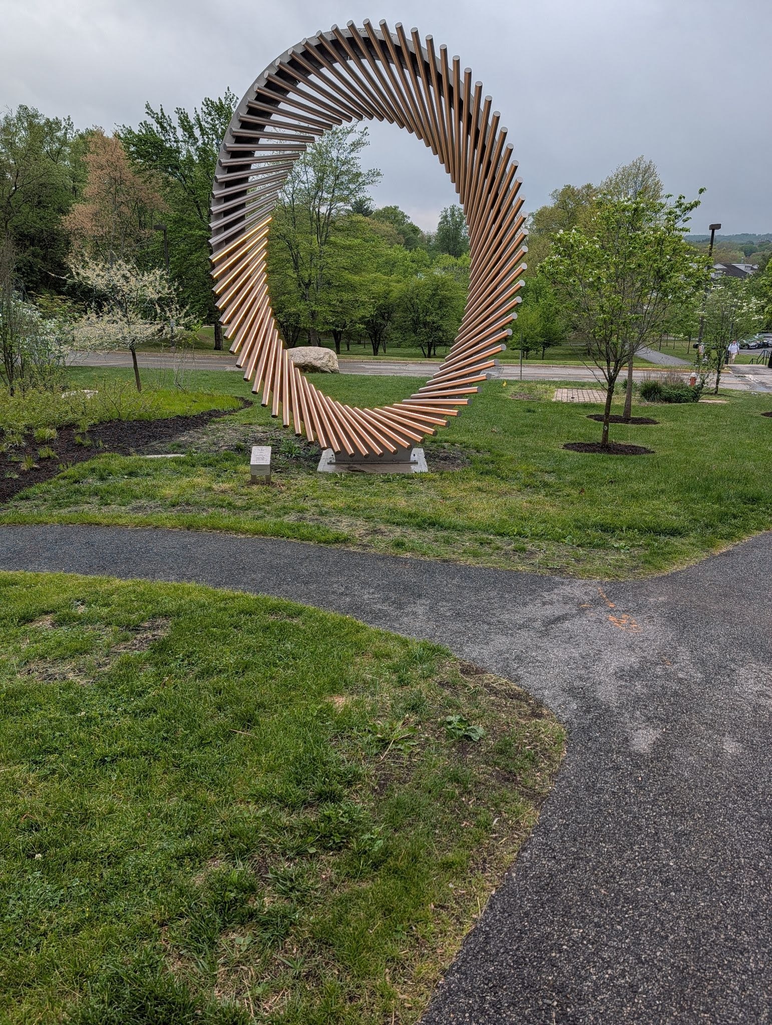 A sculpture of metal and light arranged into a tall oval.
