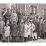 Digital Humanities Projects - Englewood Makes History. Black and white photograph from early 20th century of adults and children in winter coats in front of brick building