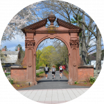 RCNJ Arch in the spring with 2 students walking passed it.