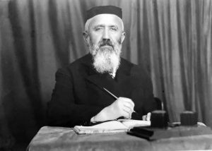 Rabbi Moshe Yosef Rubin. A middle aged man with a bear and brimless hat.