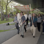 Our procession from Friends Hall to the Gross Center. The Torah is accompanied by two additional scrolls and is under a Jewish wedding canopy.