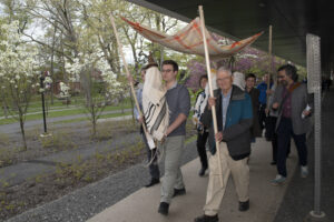 Our procession with the Torah in front, under a Jewish wedding canopy. 