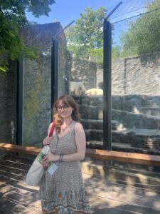 Woman in a dress in front of a polar bear enclosure
