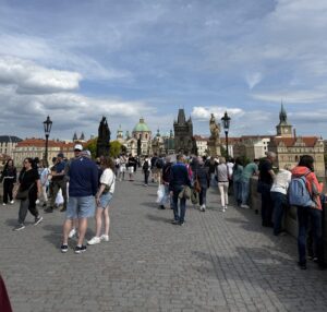 Charles Bridge with pedestrian traffic on a bright day.
