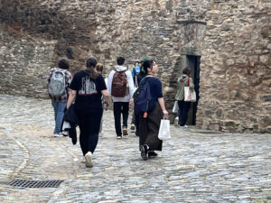 Students surrounded by stone walls