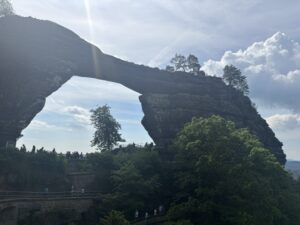 Rock feature that looks like a bridge towering over a chasm.