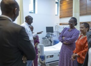Jeannette Kagame, the First Lady of Rwanda, visits the new maternity ward in King Faisal Hospital (2023). She is wearing a purple dress, surrounded by medical professionals in a beautifully appointed hospital room.