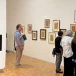 People looking at anthotype prints.
