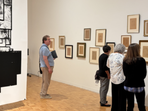 People looking at anthotype prints.