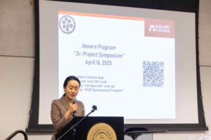 Student presenting her poster in Honors Symposium 2024
