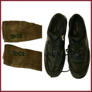 Clothing found with Hudson Shore John Doe. A pair of discolored socks and black shoes.