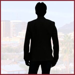 silhouette of a male looking over a city