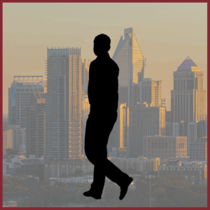 Silhouette of a man with a transparent background of the Charlotte, North Carolina skyline behind him.