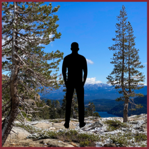 silhouette of a man overlooking mountains and tall trees in Truckee, California