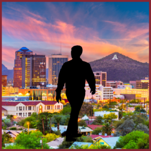 Silhouette of a person walking in front of a city (Tempe, Arizona) skyline at sunset, with a colorful sky and a mountain featuring a large letter A in the background.