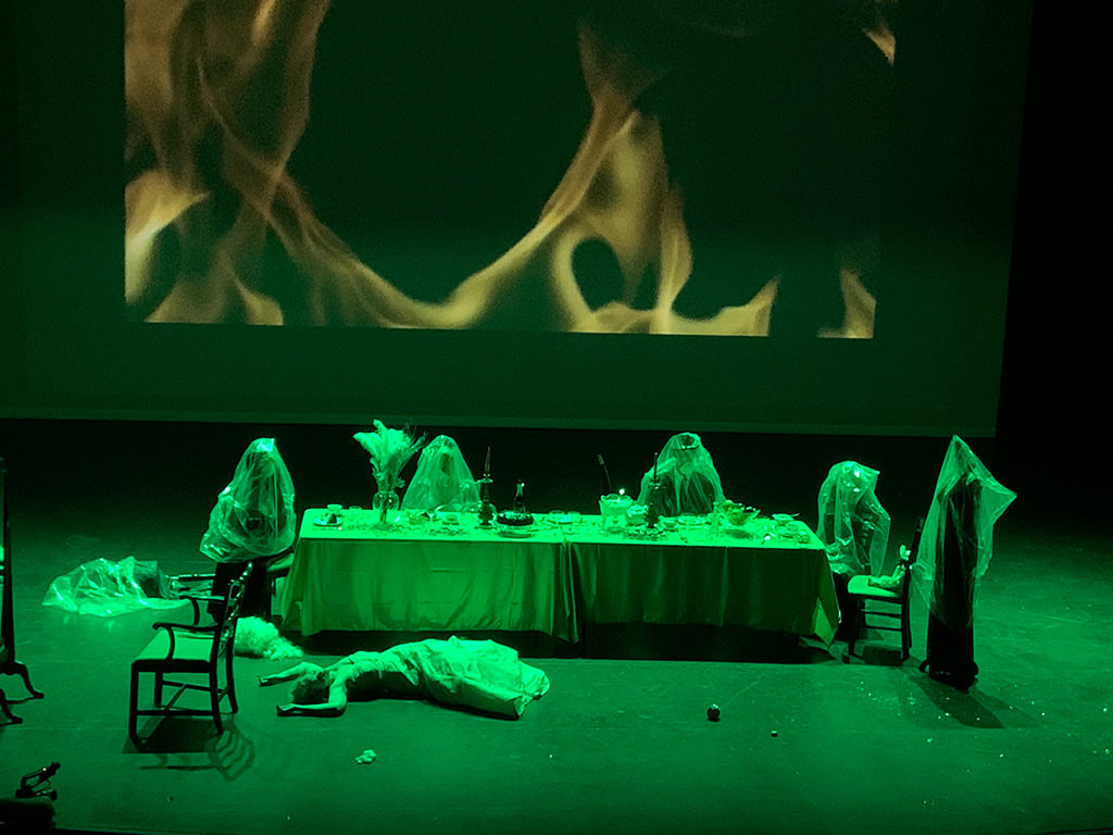 Actors on stage in green light