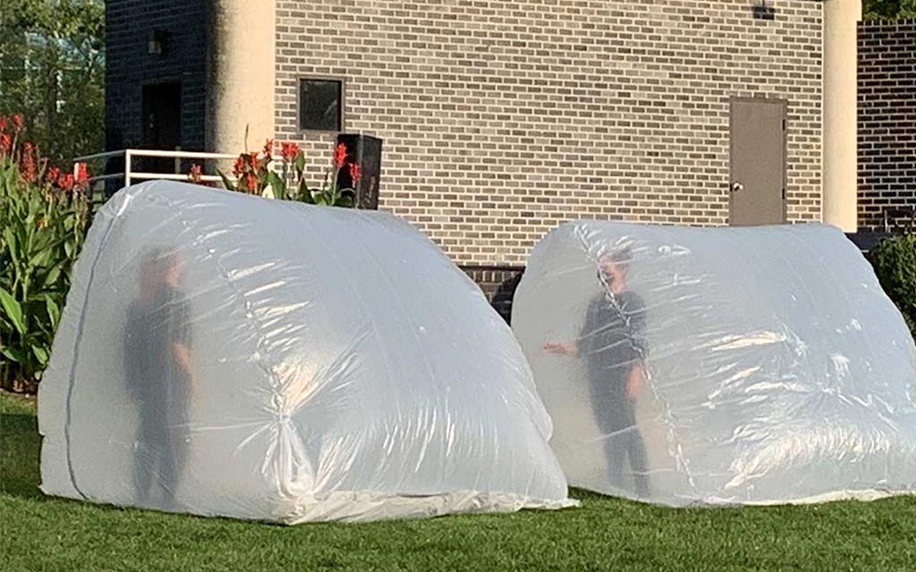 Two dancers in plastic bubbles performing at the bandshell