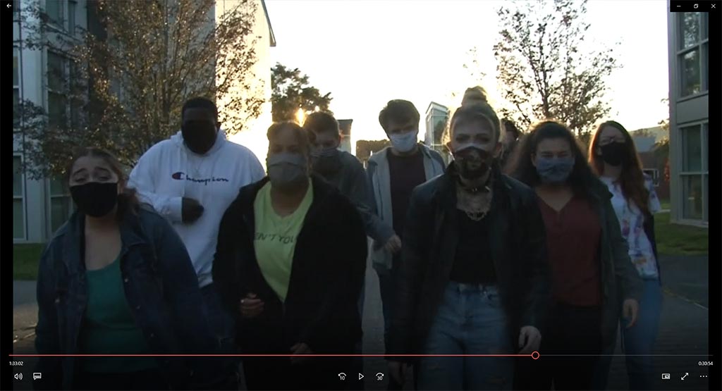 Group of performers walking toward the Berrie Center