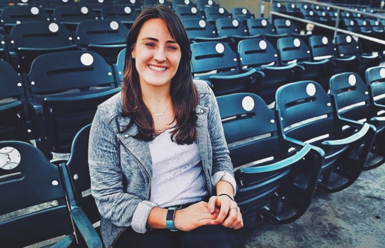 Alex Rigoli seated in baseball stadium chairs