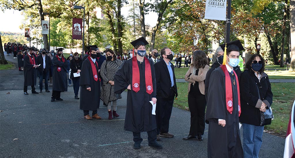 Line of students and families preparing for commencement procession