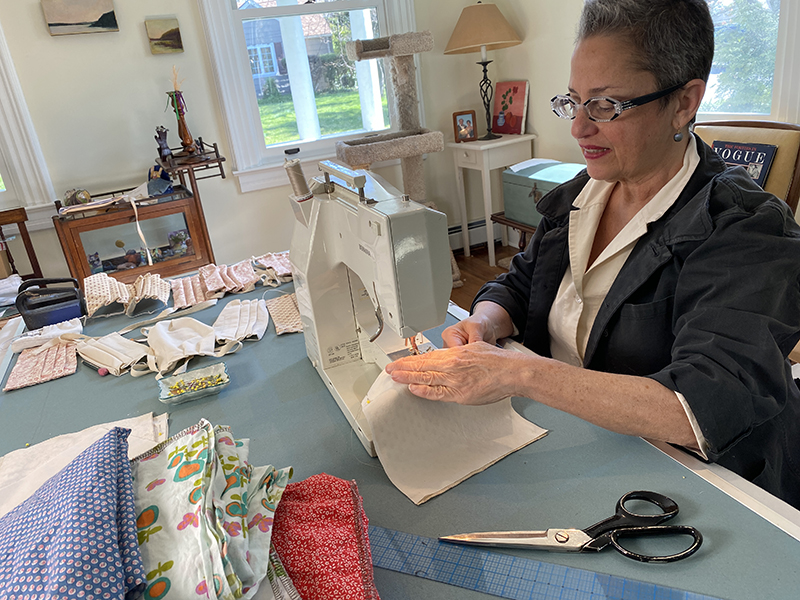 Professor Shamish seated at a sewing machine