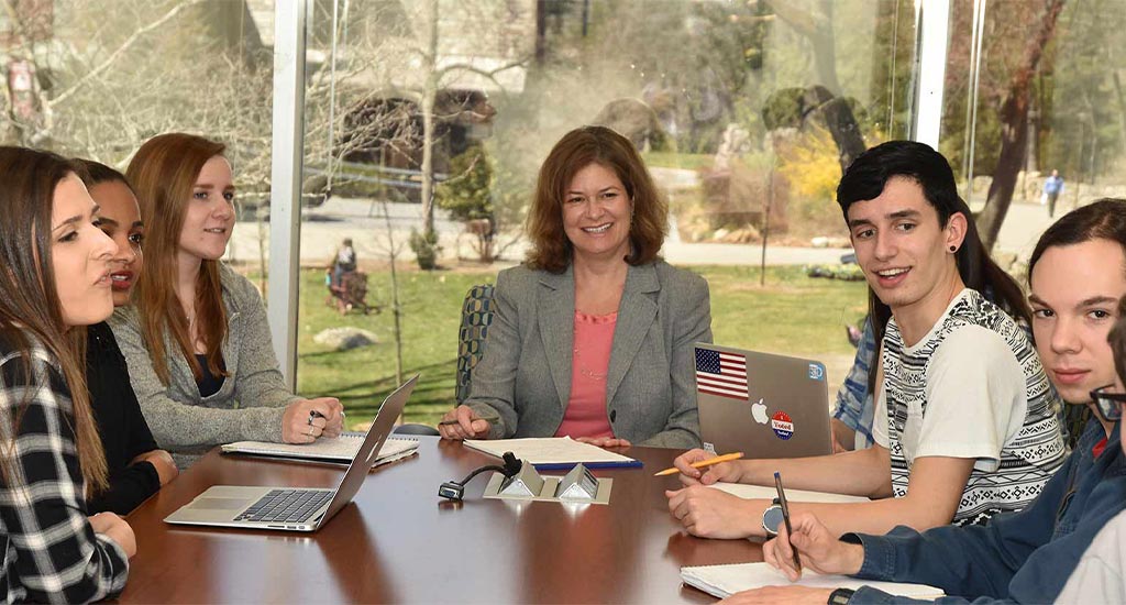 Interim Dean Susan Hagen smiling with students