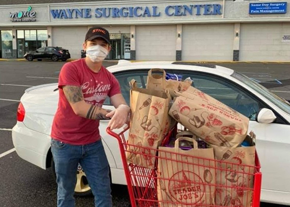 Joseph Giglio ’22 with shopping cart full of Trader Joe’s food bags