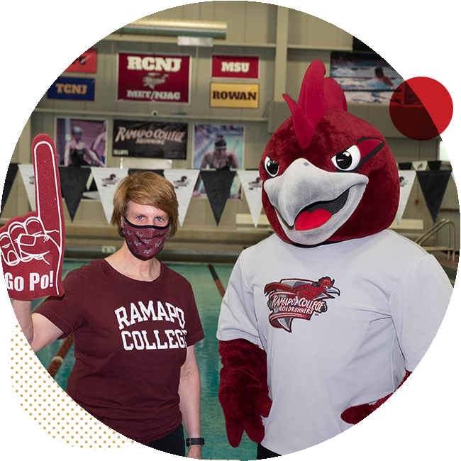 President Jebb stands next to Rocky the Roadrunner near a pool