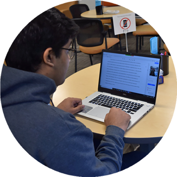 student using a laptop at a desk