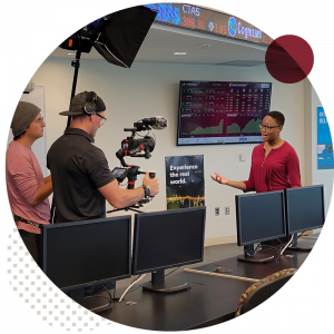 Female student filming a scene for the College Tour episode with videographer