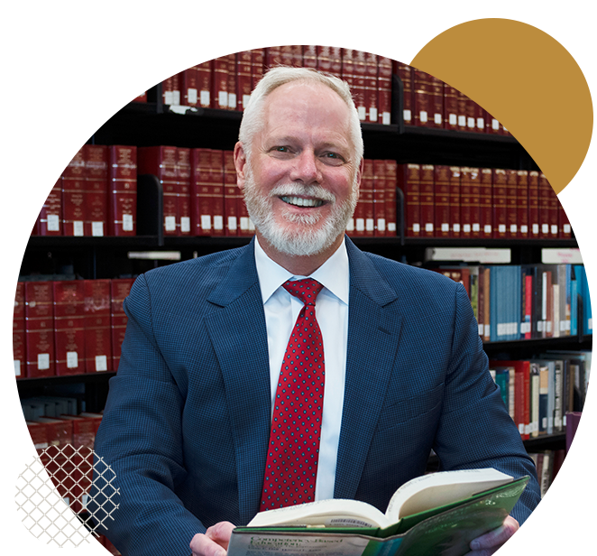 Ramapo College's Provost, Michael Middleton, with a book