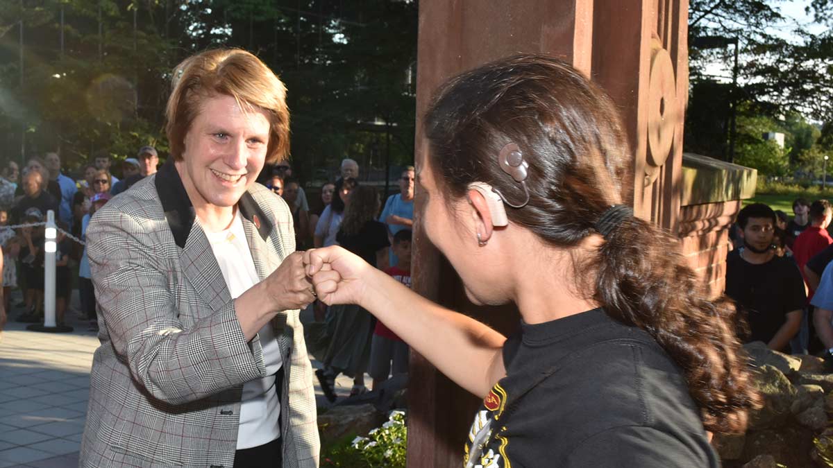 President Jebb fist bumping a student during Ramapo College's welcome Arching ceremony