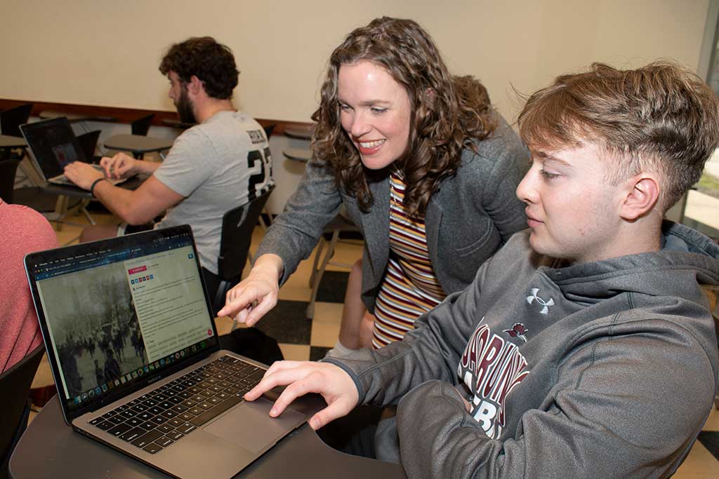 Professor Sarah Koenig helping a student