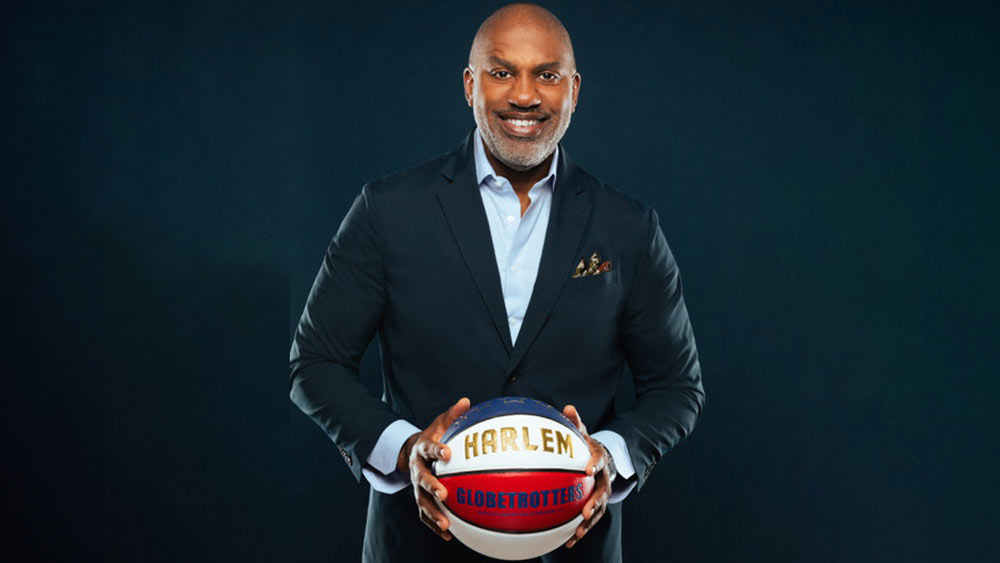 Keith Hawkins holding a Harlem Globetrottrers basketball