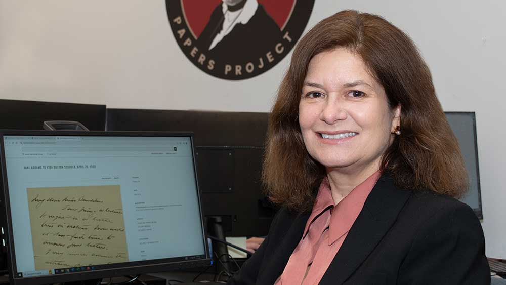 Susan Hangen, Ramapo’s dean of the School of Humanities and Global Studies sitting at a desk