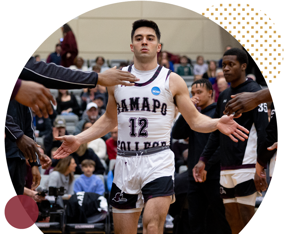 Ramapo college basketball athlete, Peter Gorman, slapping hands with opposite team