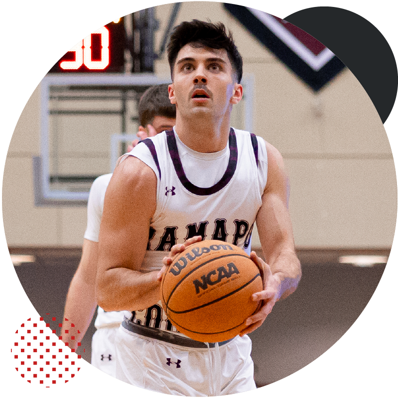Ramapo College basketball athlete, holding a basketball before trying to shoot a hoop