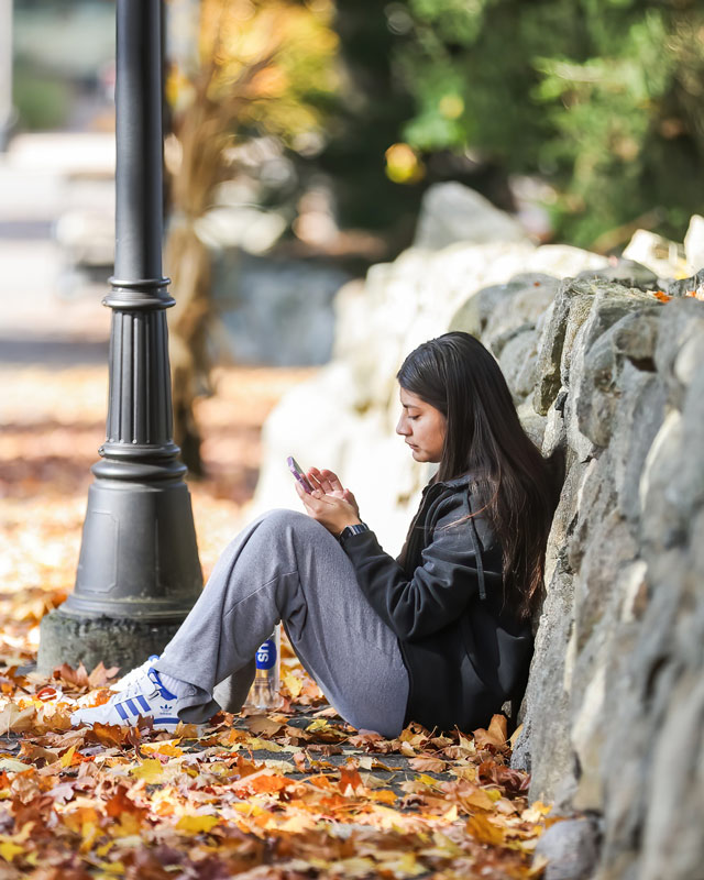 Ramapo College student watching shows on phone