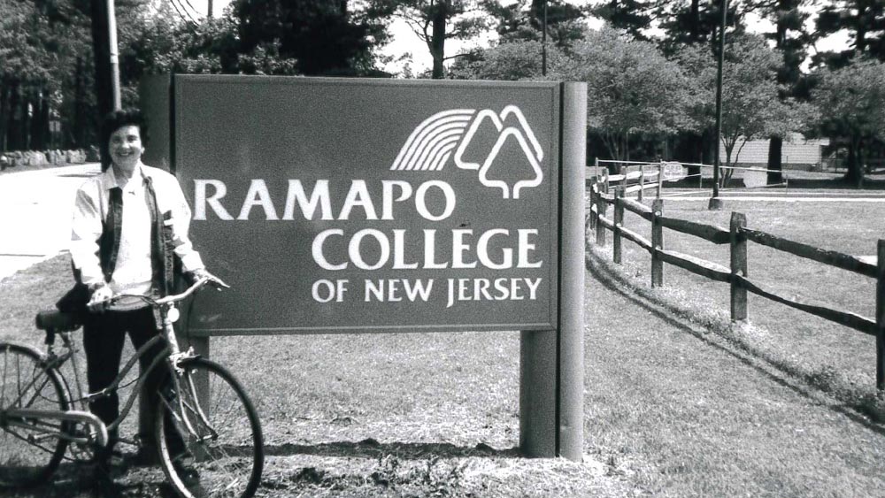 Three-Living-Generations-of-Ramapo-Alumni_fall2025-home Rose Marie Mark ’05 next to the Ramapo College sign.
