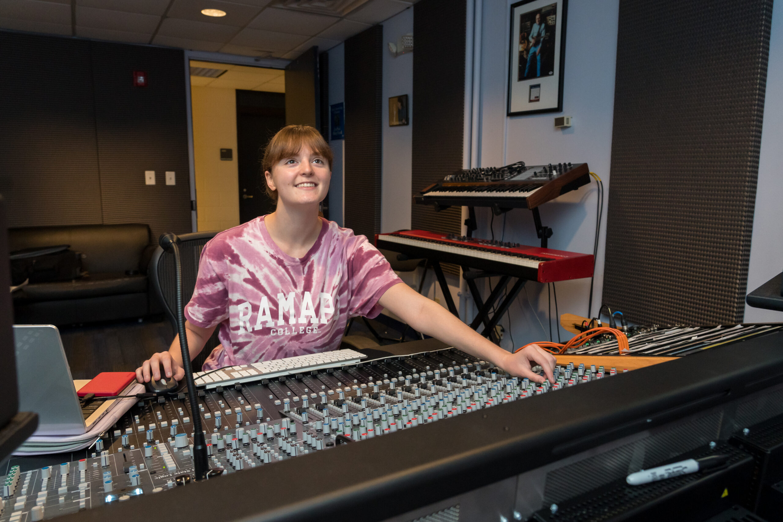 A Ramapo College student works at the mixing console in the Les Paul Studio, where students gain hands-on experience producing music in a professional recording environment.