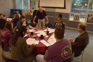 IRS Special Agent Robert Glantz discusses criminal financial records with students during the Adrian Project.