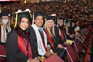 2022 Ramapo College Graduates at the Commencement ceremony, seated in a row wearing regalia