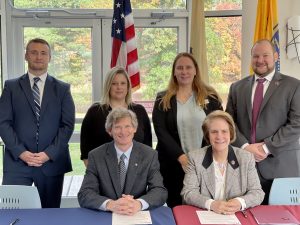 a group photo of Sussex and RCNJ officials after singing a new 3+1 degree path.