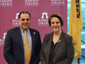 Senator Paul Sarlo and President Jebb pose in next to the NJ state flag