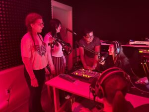 Students in the radio station booth on-air.